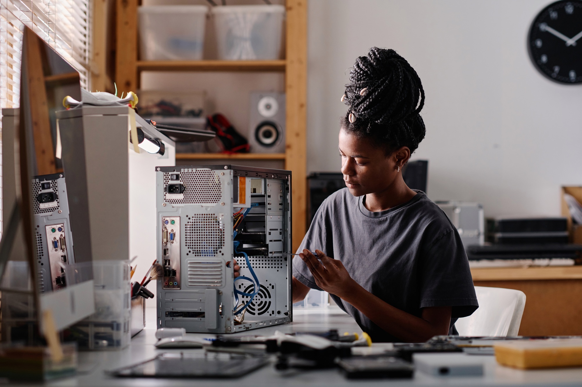 African American Woman Repairing System Unit of Computer in Workshop