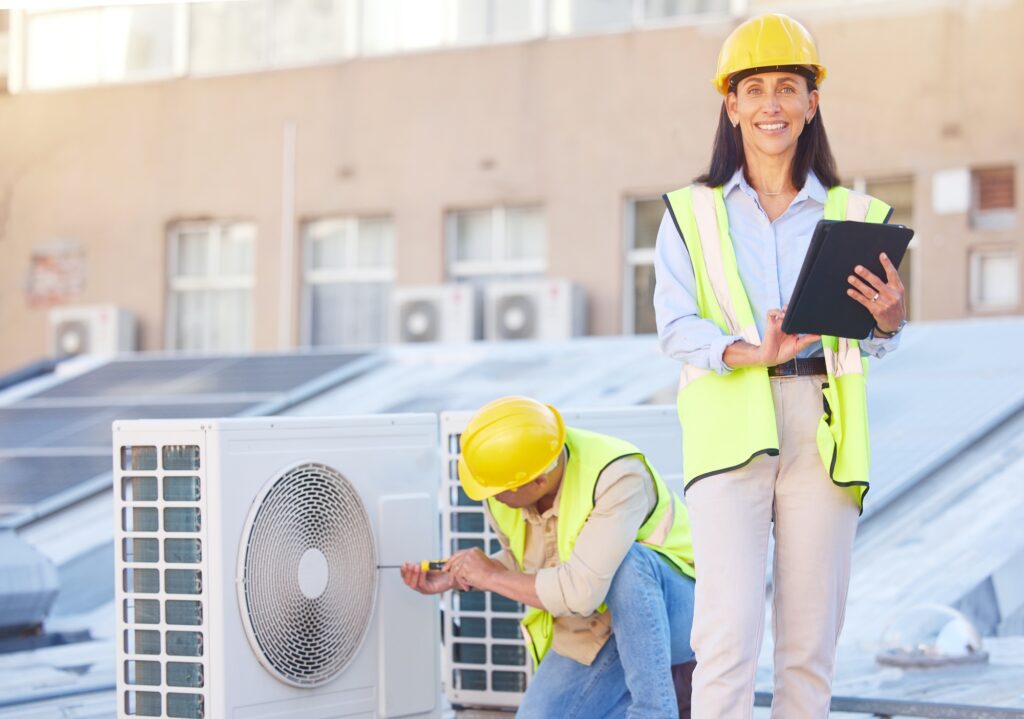 Air conditioner, building maintenance and teamwork with tablet, smile and development with engineer