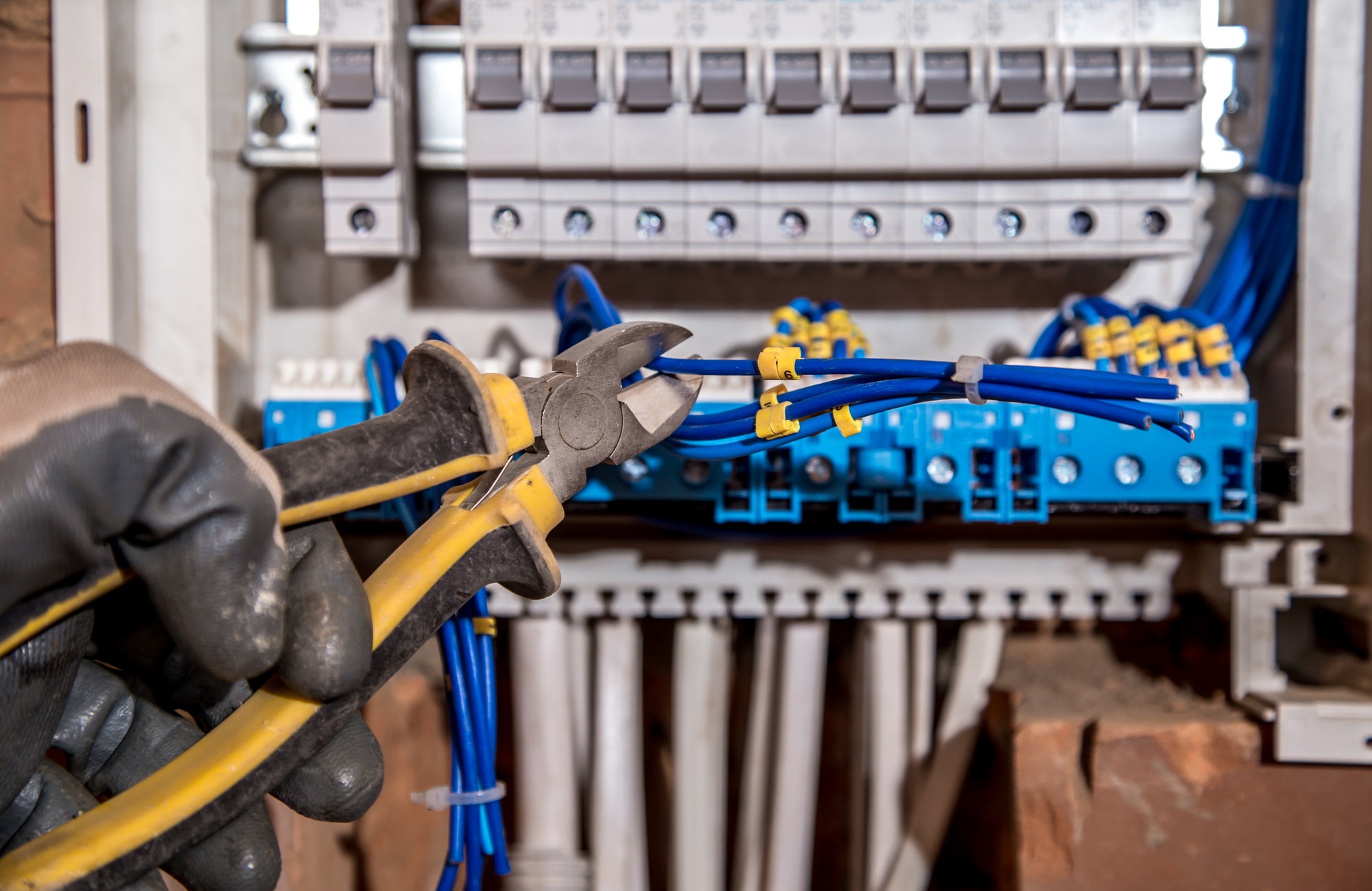 the Assembly of the electrical panel, electrician job, a robot with wires and circuit breakers